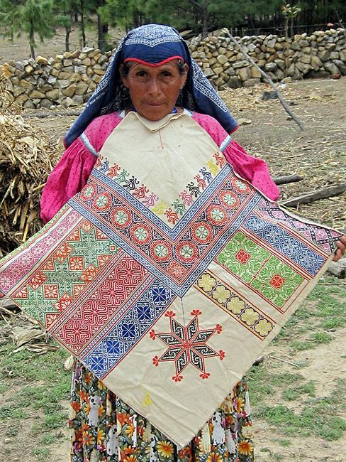Marcella Sandoval and an example of her fine embroidery.