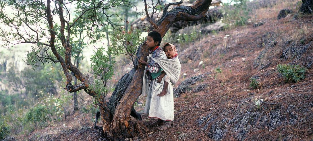 A young girl cares for her baby brother - Photograph ©Juan Negrín 1980 